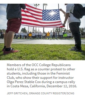 Members of the OCC College Republicans hold a U.S. flag as a counter protest to other students, including those in the Feminist Club, who show their support for instructor Olga Perez Stable Cox during a campus rally in Costa Mesa, California, December 12, 2016.  Jeff Gritchen, Orange County Register/SCNG